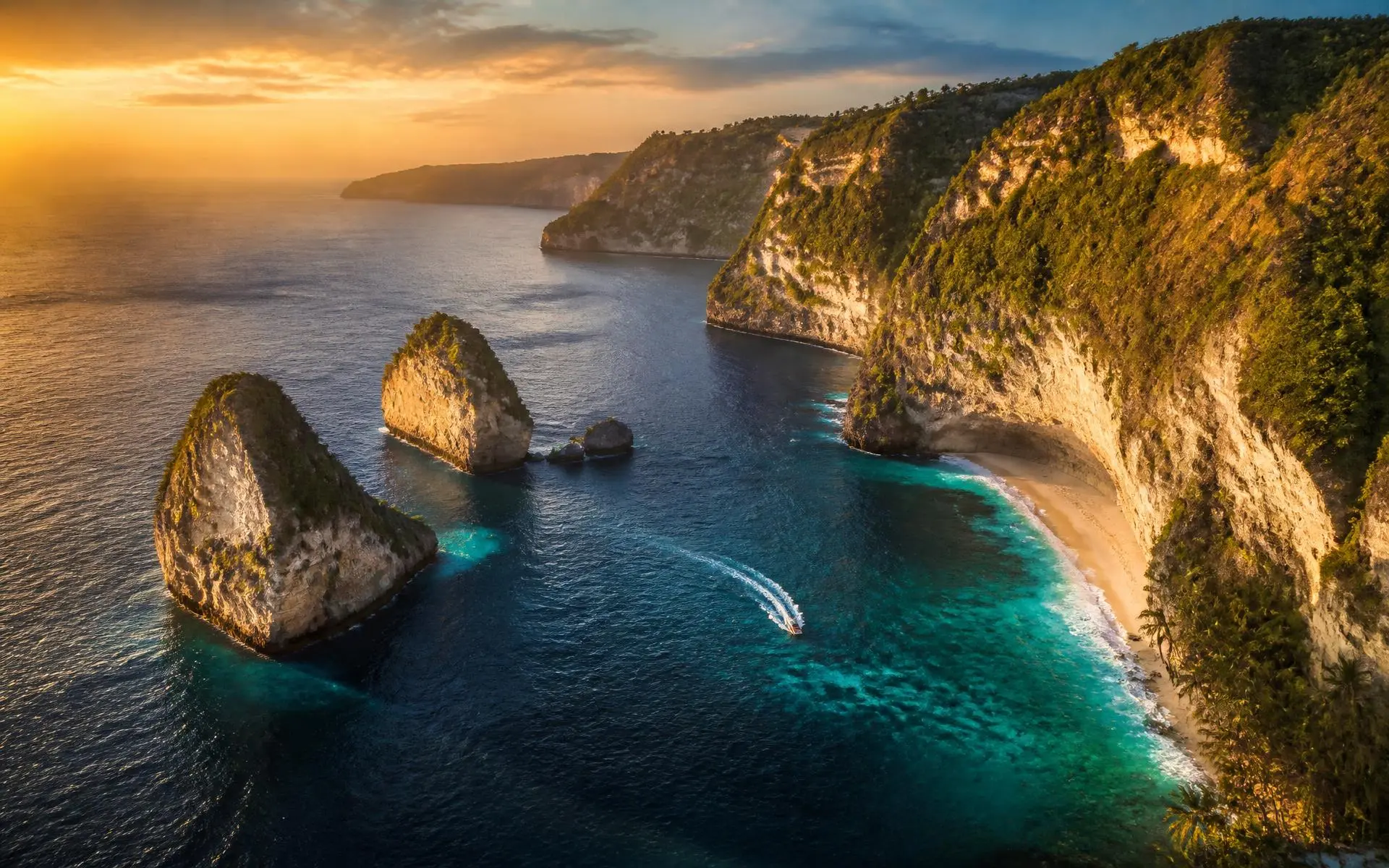 Aerial view of a turquoise tropical coastline at golden hour
